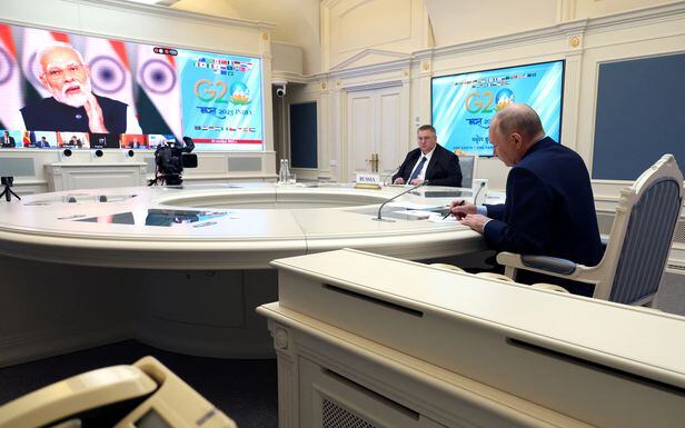 Russian President Vladimir Putin and Deputy Prime Minister Alexei Overchuk attend the G20 virtual summit, as Indian Prime Minister Narendra Modi is seen on a screen, during a video link in Moscow, Russia, November 22, 2023. Sputnik/Mikhail Klimentyev/Kremlin via REUTERS ATTENTION EDITORS - THIS IMAGE WAS PROVIDED BY A THIRD PARTY.