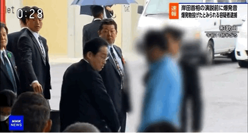 15일 오전 11시 30분쯤 기시다 후미오 일본 총리가 일본 와카야마(和歌山)현 사이카자키 어항(漁港)에서 연설하기 전 상황. 빨간 옷을 입은 남성이 용의자를 제압하고 있다./NHK
