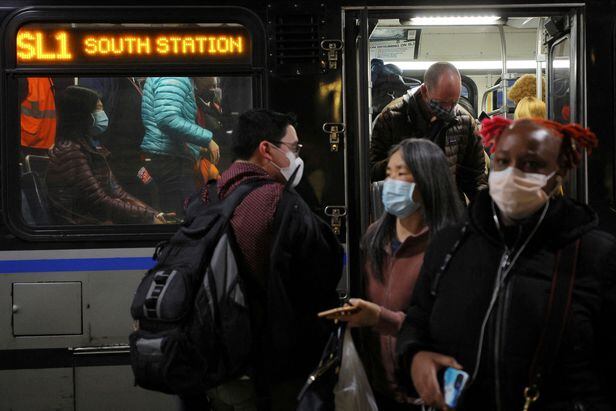 Travelers wearing masks arrive at Boston Logan International Airport via an MBTA Silver Line bus on April 19, 2022./Reuters