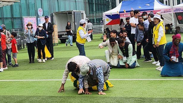 지난달 21일 경기도 용인시 용인시청 앞 운동장에서 열린 '2023 다문화 한마당 축제' 체육대회 참가자들이 '캥거루 달리기'를 하는 모습. 백팀의 바야지드 무함마드(32)씨와 홍기선(82)씨가 앞으로 넘어지자 팀원들은 "괜찮아"라고 웃으며 응원했다./서보범 기자